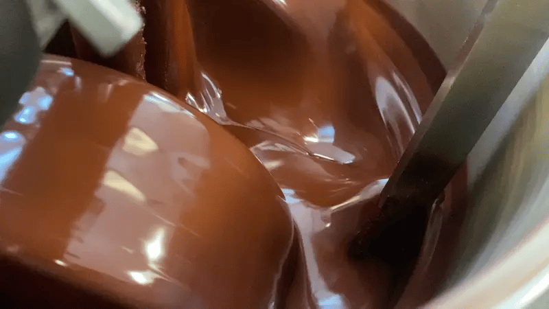 Chocolate being refined in a melangeur