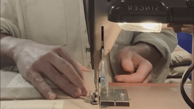 Person sews chocolate into jiffy bags on a vintage singer sewing machine