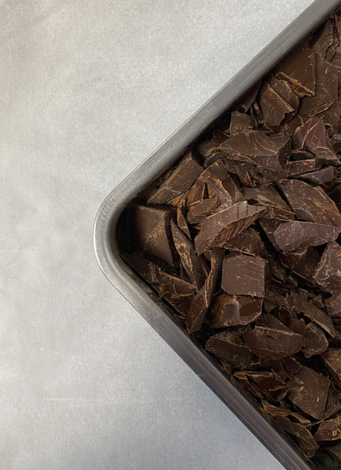 Stainless steel tray of chocolate chunks.